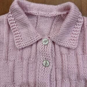 Pink knit cardigan with floral enamel buttons